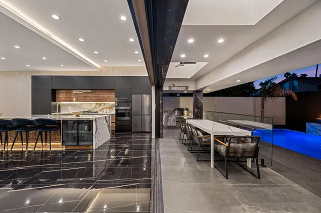 a kitchen with a table chairs and a refrigerator