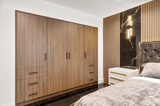 a living room with a bed and next to a window