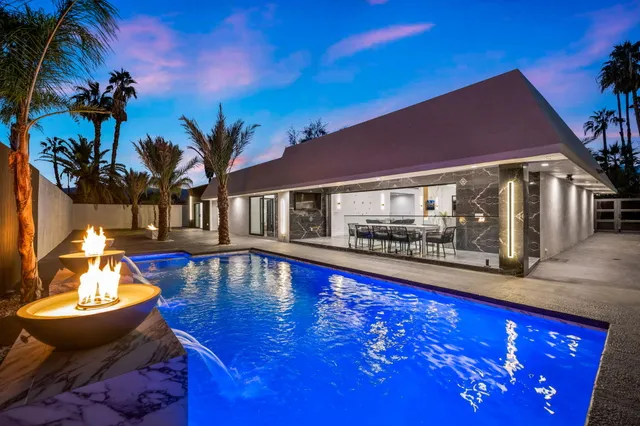 a kitchen with stainless steel appliances a stove top oven and a refrigerator