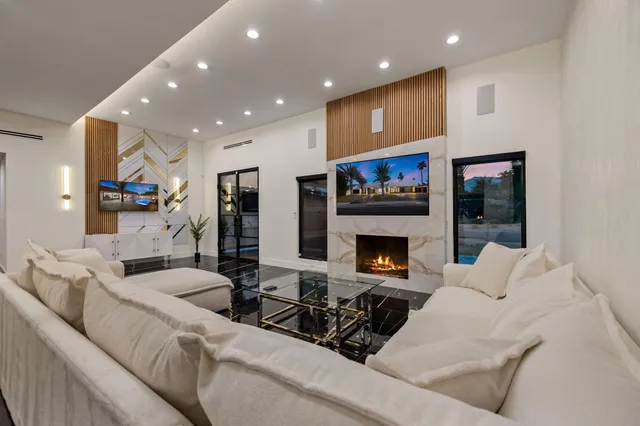 a living room with furniture and a fireplace