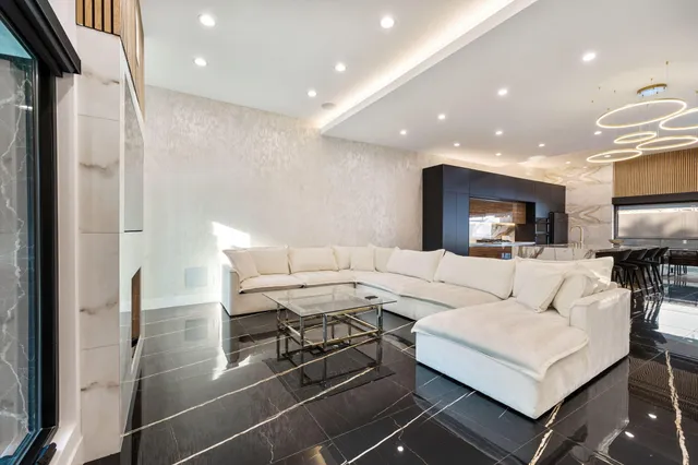 a living room with furniture and a chandelier
