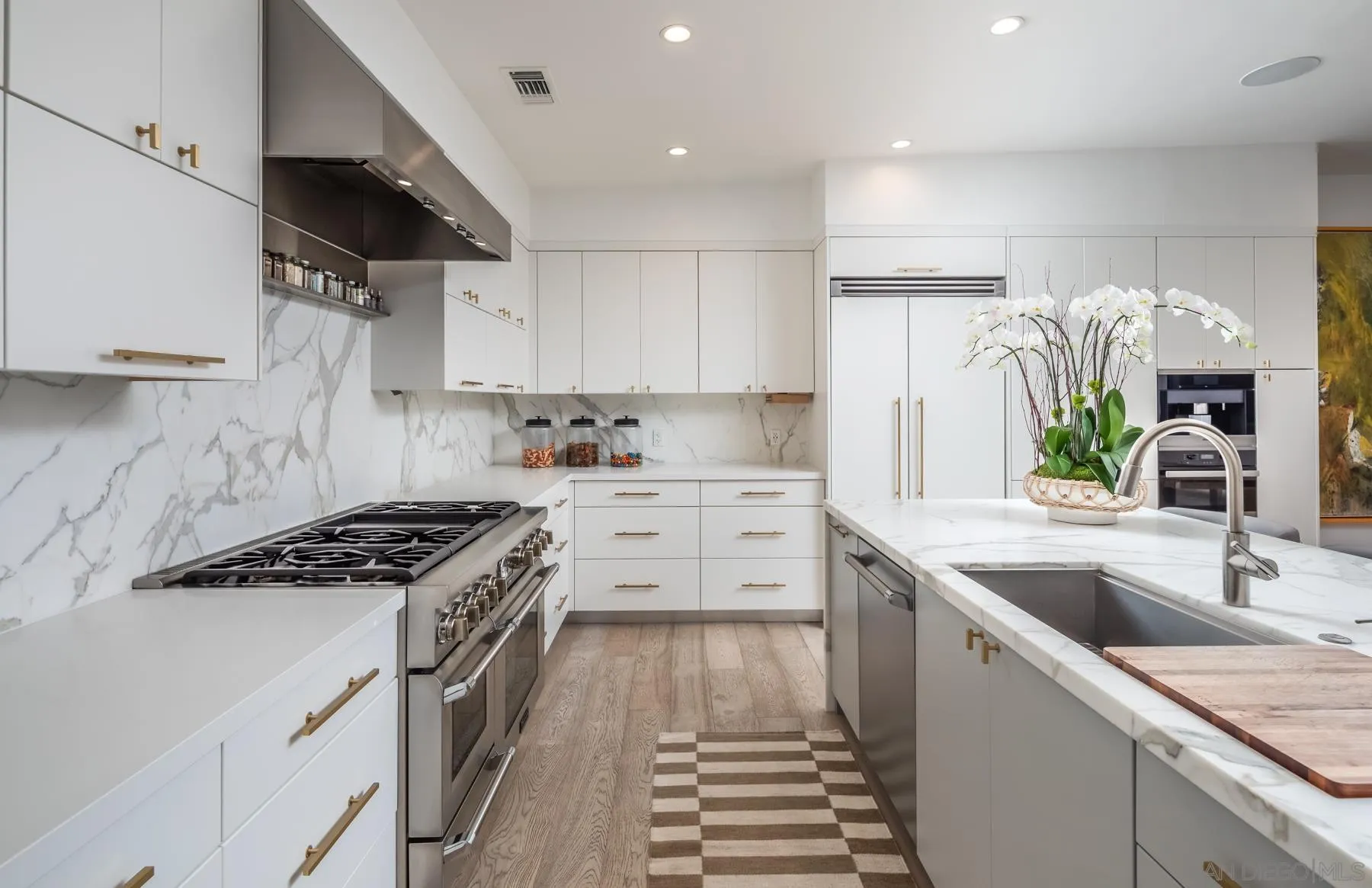 303 Hillcrest Drive Encinitas, CA 92024 - Photo 10 of 28 a kitchen with granite countertop a sink stove and cabinets