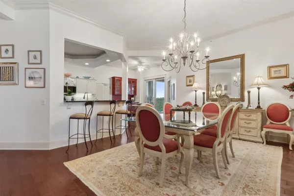 a kitchen with granite countertop a sink a stove top oven a counter space and cabinets