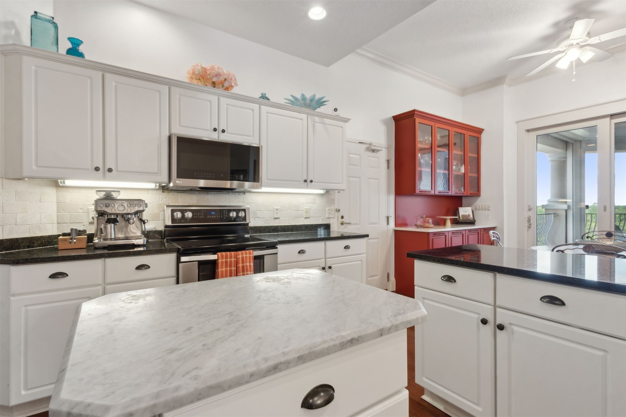 418 Beachside Place, Unit 418 Fernandina Beach, FL 32034 - Photo 20 of 91 a kitchen with granite countertop a sink a stove top oven a counter space and cabinets