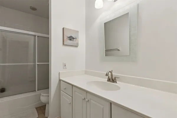 a spacious bedroom with a bed and a television