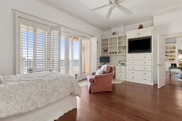 a view of a livingroom with a potted plant a rug and wooden floor