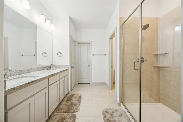 a bathroom with a granite countertop sink mirror and shower