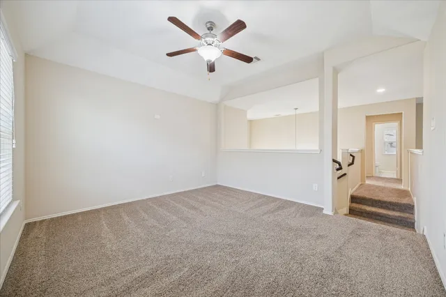 an empty room with closet and windows