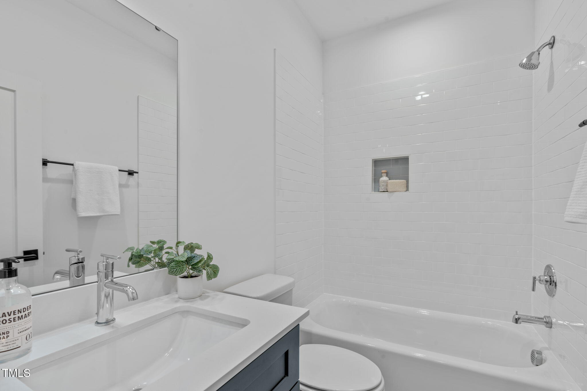 5061 Lundy Drive, Unit 101 Raleigh, NC 27606 - Photo 23 of 49 a bathroom with a granite countertop sink a toilet and bathtub