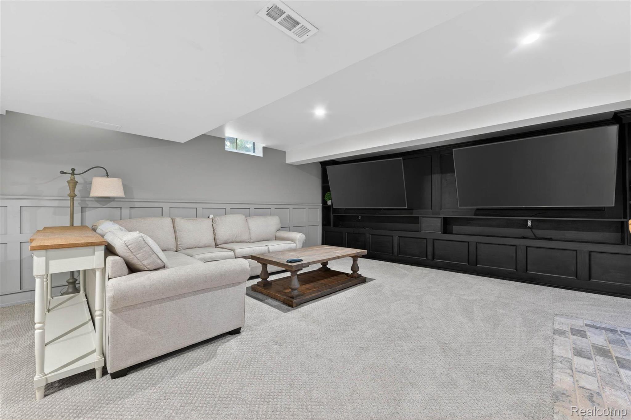 371 Lone Pine Circle Rochester, MI 48307 - Photo 39 of 59 Spacious entertainment area featuring extensive built-in cabinetry, recessed lighting, and light-toned carpeting