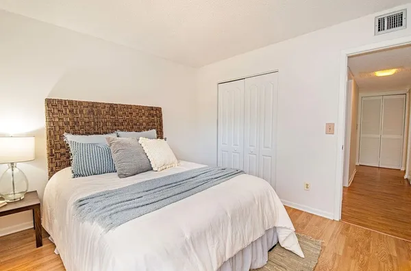 a bedroom with a bed and a night stand