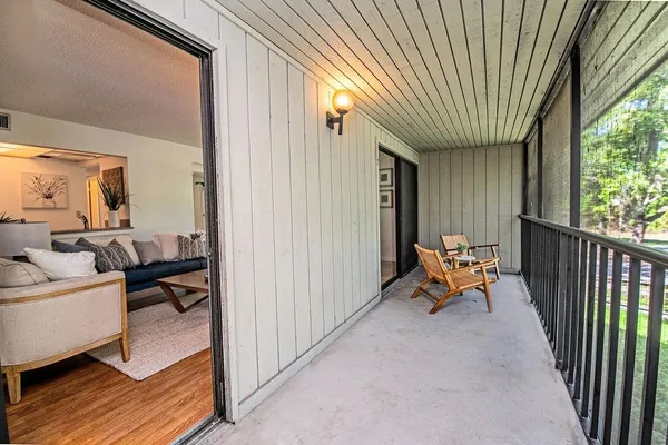 a view of a house with swimming pool and sitting area