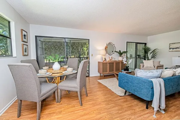 a living room with furniture and a wooden floor
