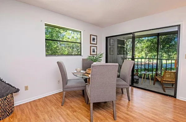 a view of a dining room with furniture window and wooden floor