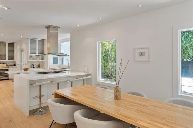 a kitchen with a sink cabinets and wooden floor