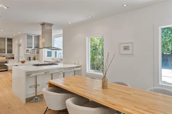a kitchen with a sink cabinets and wooden floor