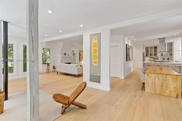 a view of a living room kitchen and a wooden floor