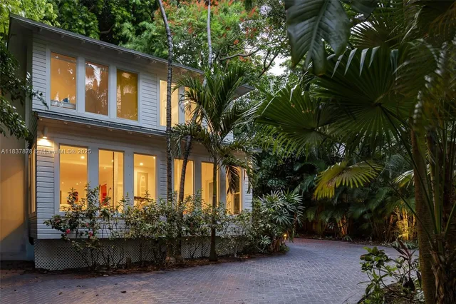 a couple of potted plants in front of house