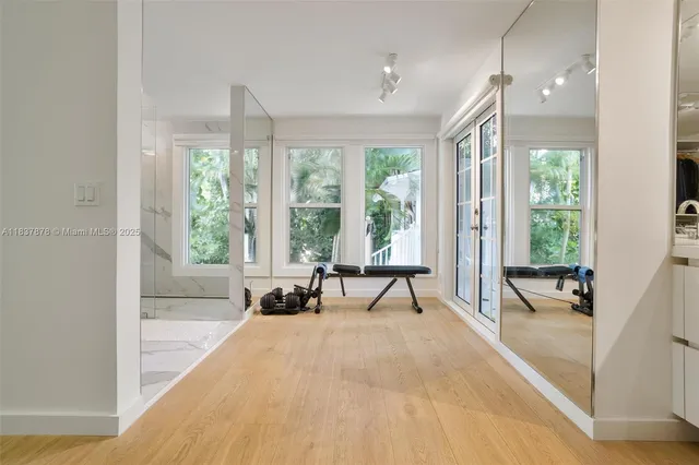 a spacious bathroom with a large window and a bath tub