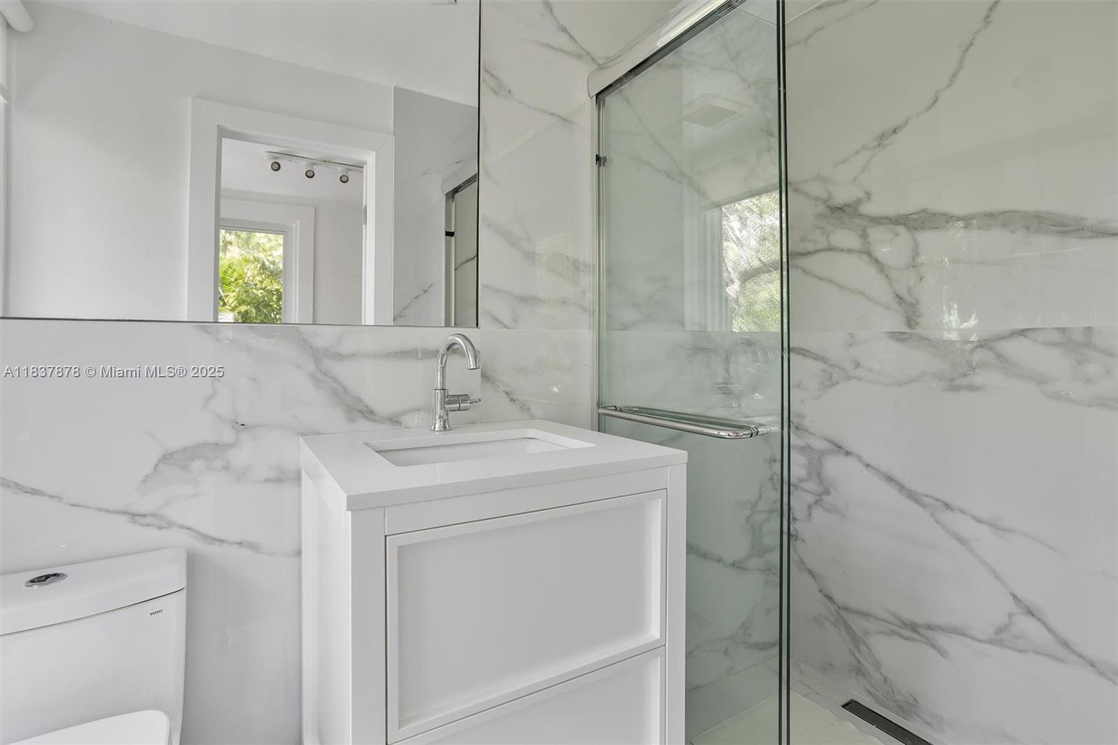 4286 Douglas Road Miami, FL 33133 - Photo 26 of 51 a bathroom with a sink and a mirror