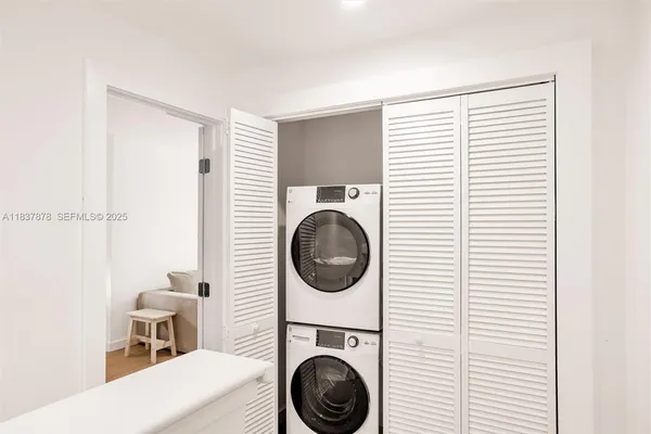 a view of a hallway with washer and dryer