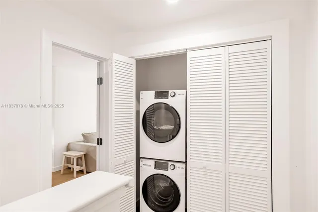 a view of a hallway with washer and dryer