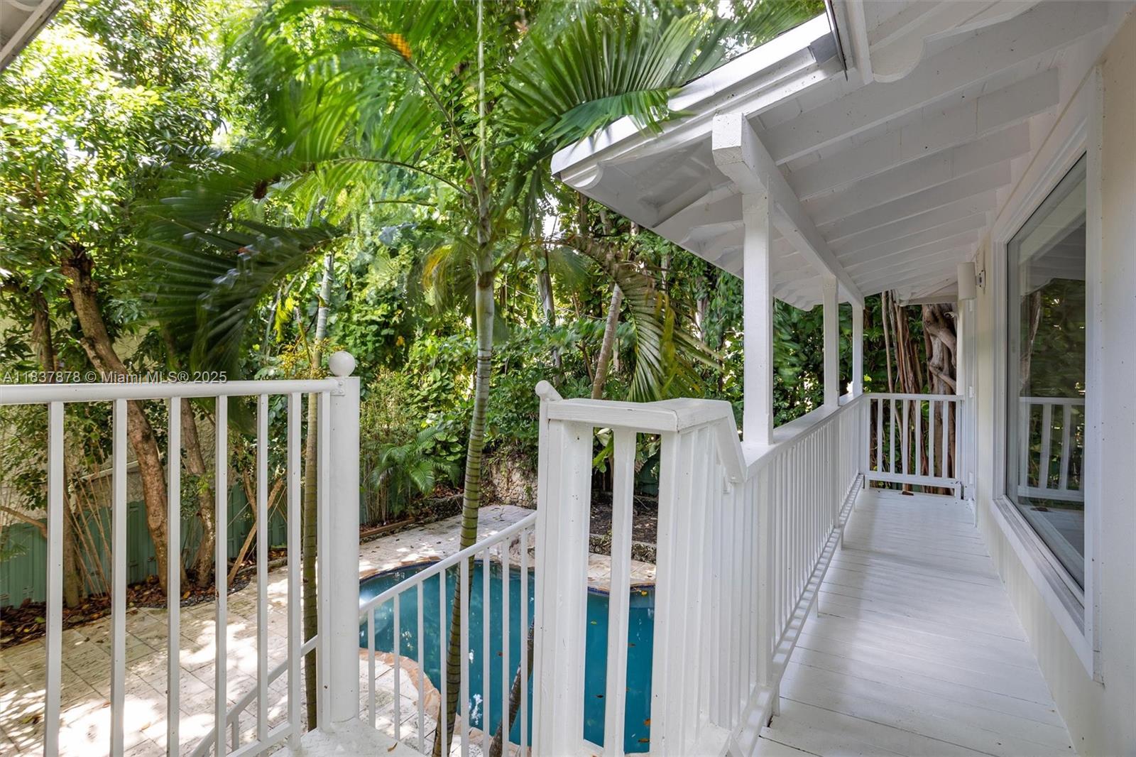 4286 Douglas Road Miami, FL 33133 - Photo 32 of 51 a view of a house with backyard and wooden fence