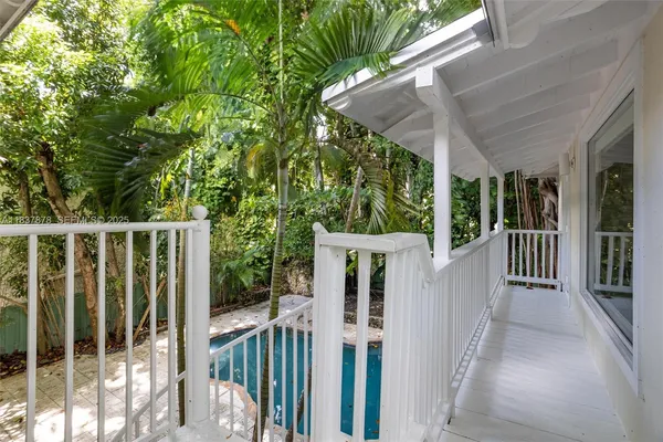 a view of a house with backyard and wooden fence