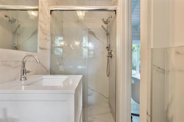 a bathroom with a shower and a sink