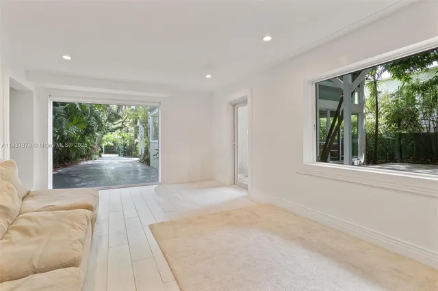 a view of a room with a large window and front door