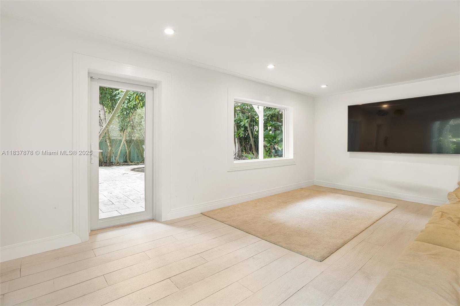 4286 Douglas Road Miami, FL 33133 - Photo 38 of 51 a view of an empty room with a window and a flat screen tv