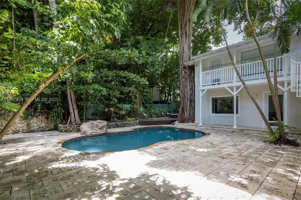 a view of a house with backyard and sitting area