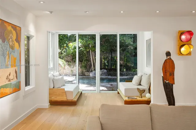 a living room with furniture and a floor to ceiling window