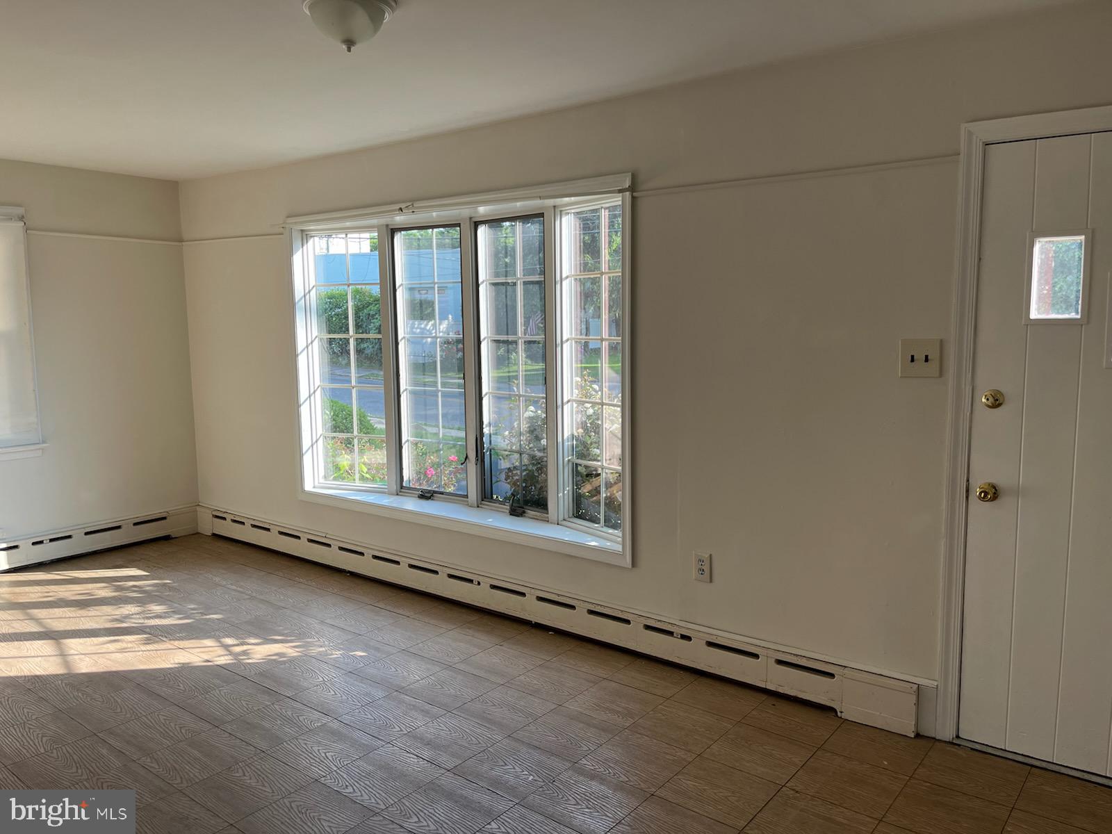 2317 Jenkintown Road Glenside, PA 19038 - Photo 11 of 16 an empty room with wooden floor and windows