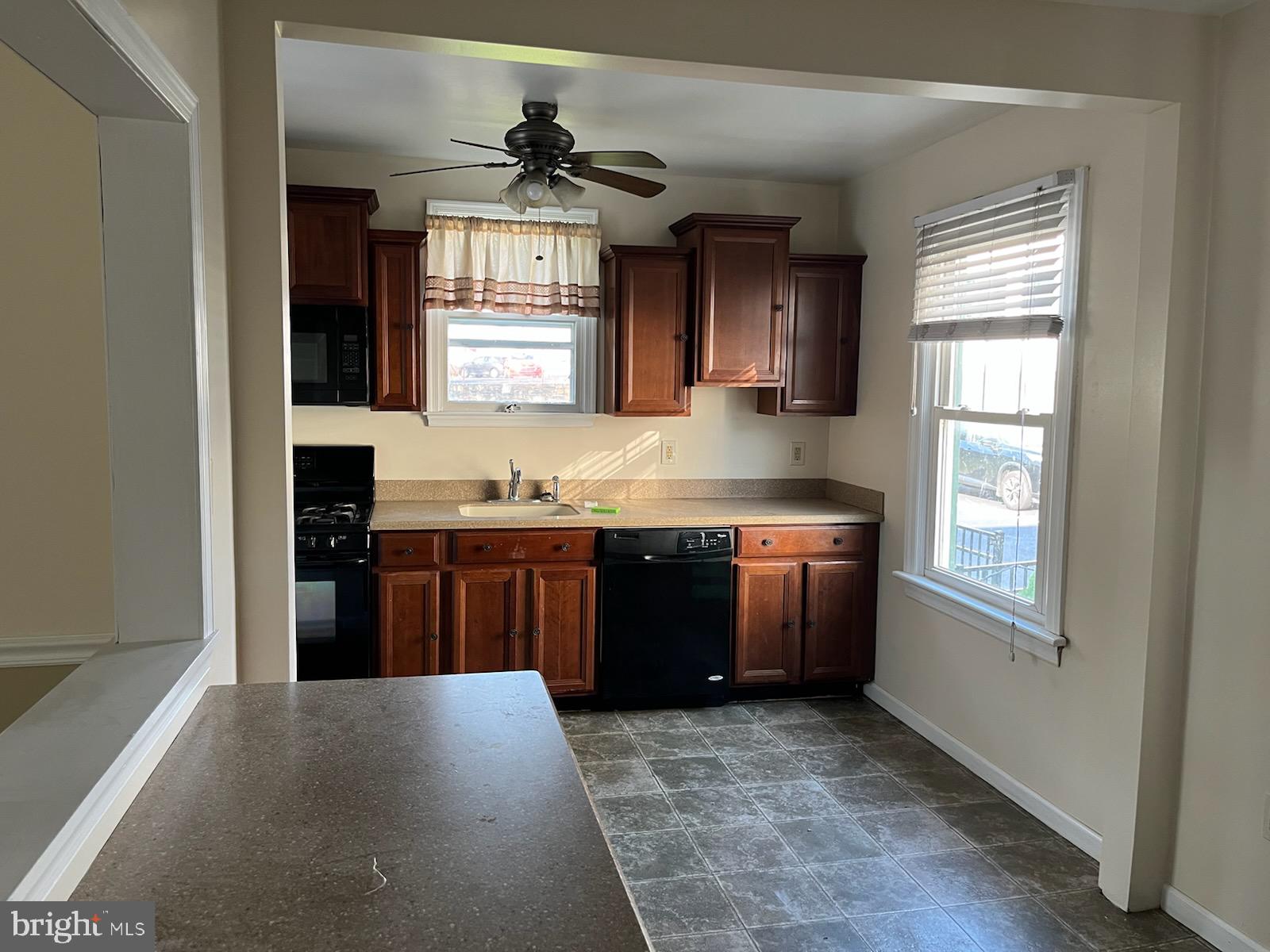2317 Jenkintown Road Glenside, PA 19038 - Photo 14 of 16 a kitchen with stainless steel appliances granite countertop a stove a sink and a refrigerator