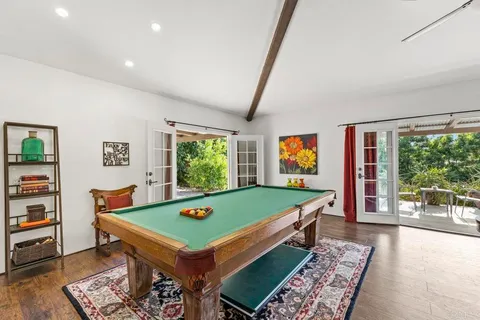 a bedroom with a bed and a tv on the dresser