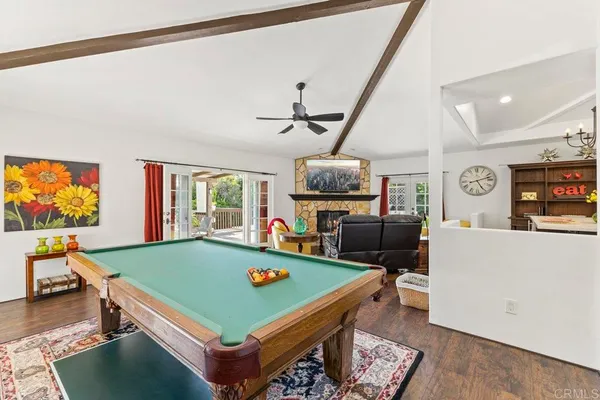 a room with furniture pool table and flat screen tv
