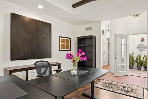 a view of dining room with furniture and flower pot