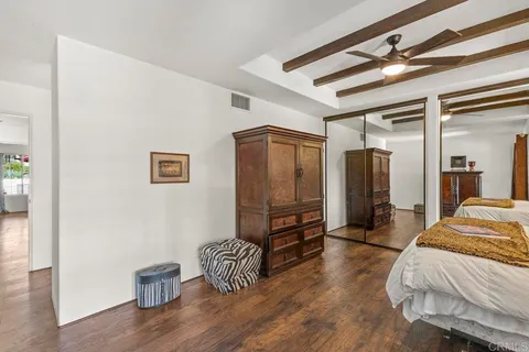 a living room with furniture kitchen view and a large window