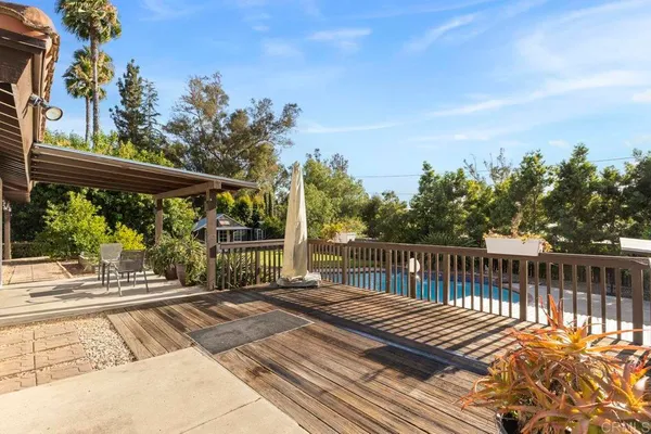 a view of a backyard with chairs potted plants