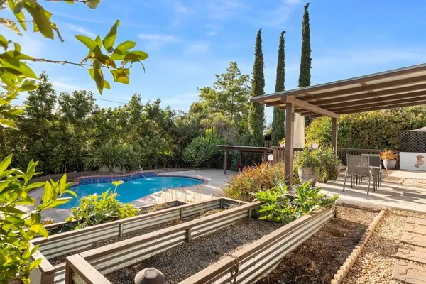 a view of a house with pool and chairs