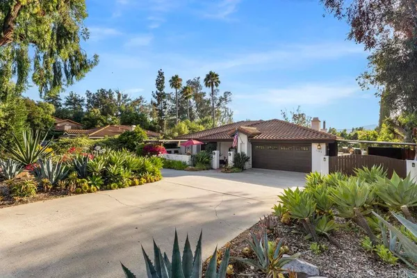 a front view of a house with a yard and a garage