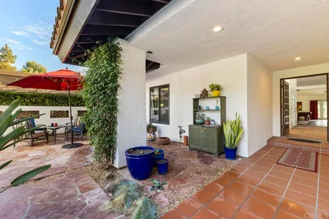 a living room with furniture a fireplace and a floor to ceiling window