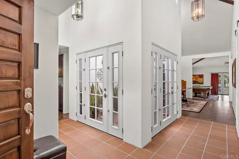 a kitchen view with stainless steel appliances granite countertop a sink dishwasher and a dining table with wooden floor