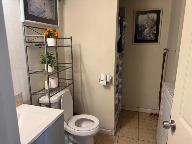a bathroom with a toilet and a shower