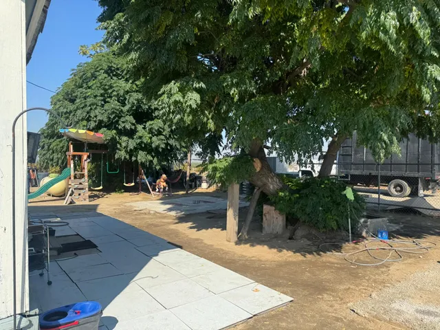 a view of a backyard both side of the house