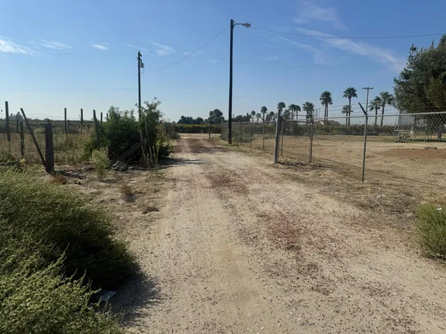 a view of a garden with tall buildings