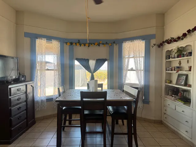 a dining room with furniture and window