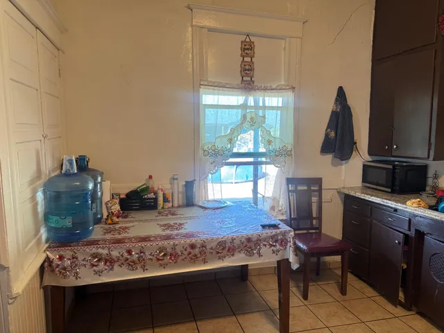 a kitchen with a table and chairs in it