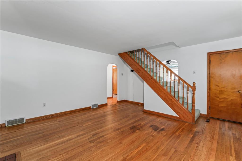 122 Georgetown Road Beaver Falls, PA 15010 - Photo 18 of 44 a view of an empty room with wooden floor